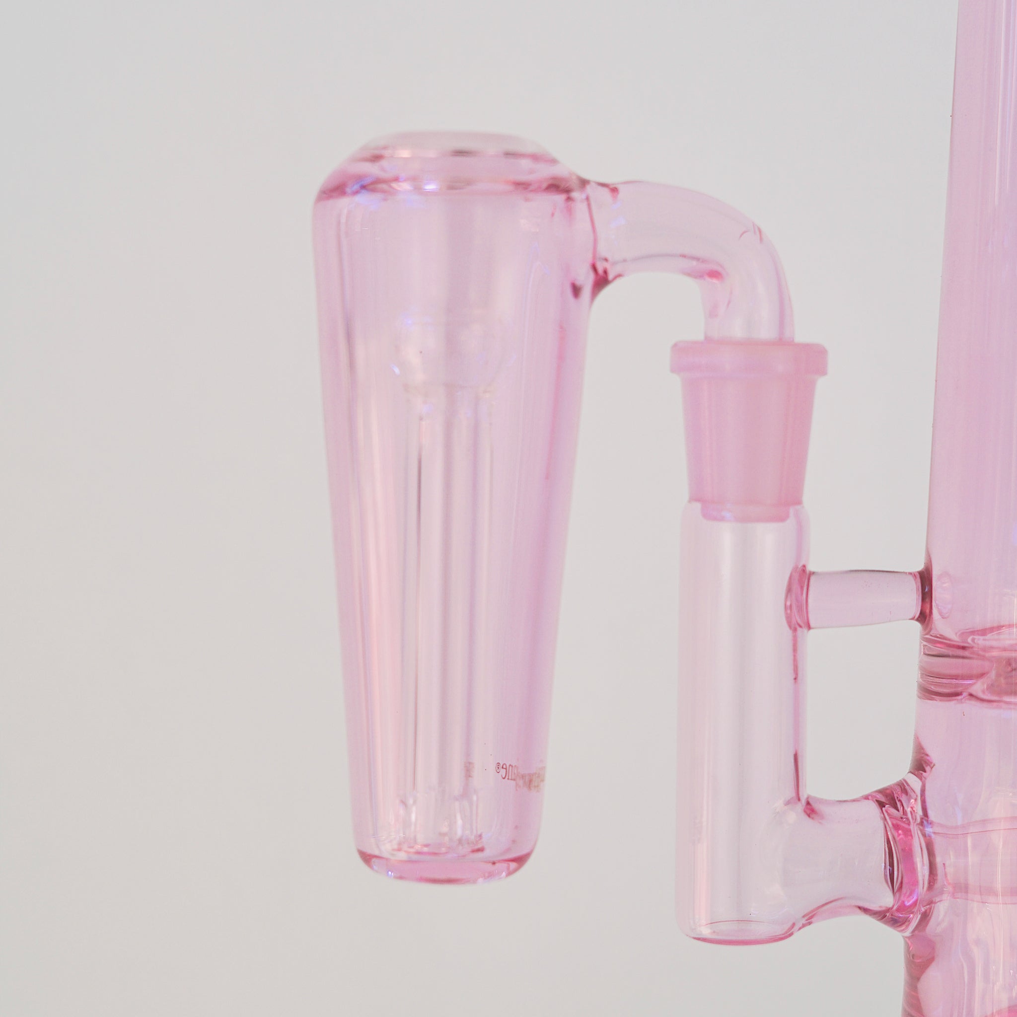 Close up of conical pink glass ash catcher, fit on a 90 degree joint bong