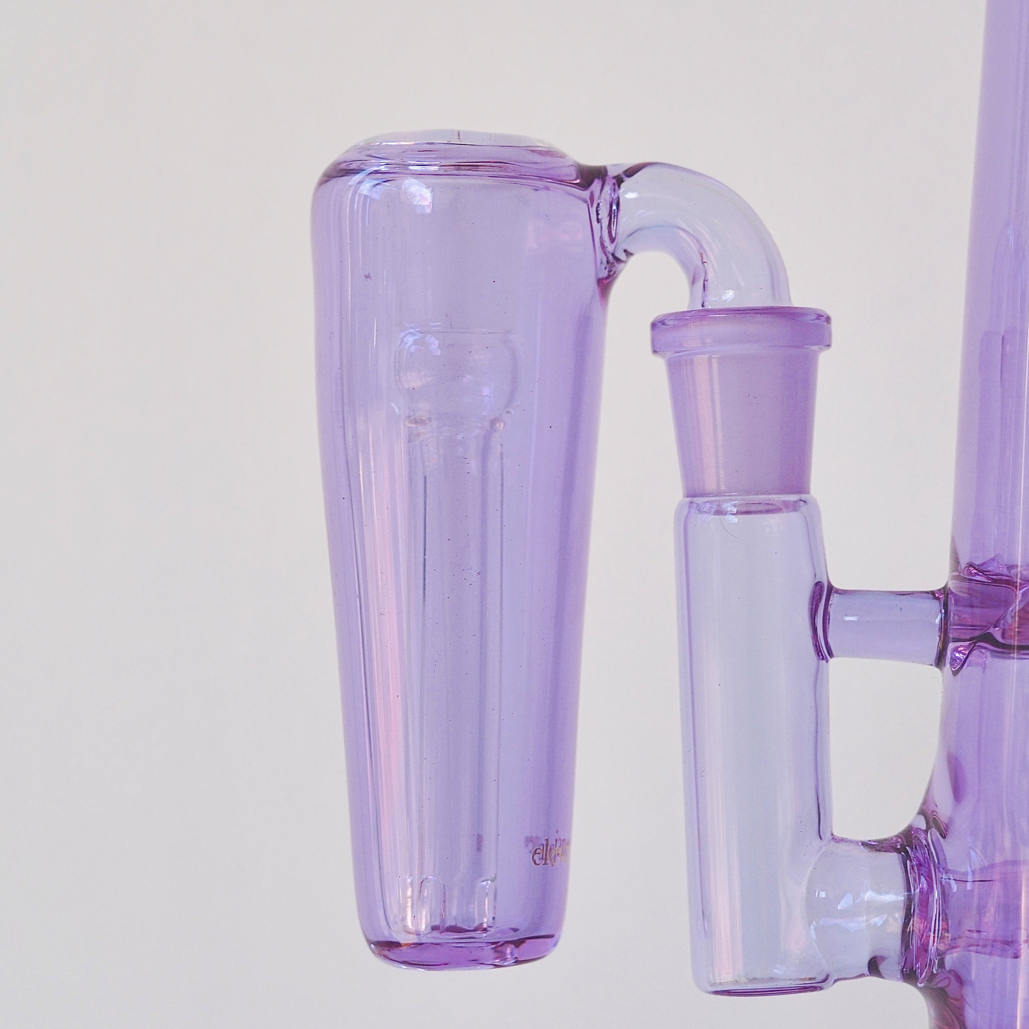 Close up of conical purple glass ash catcher, fit on a 90 degree joint bong