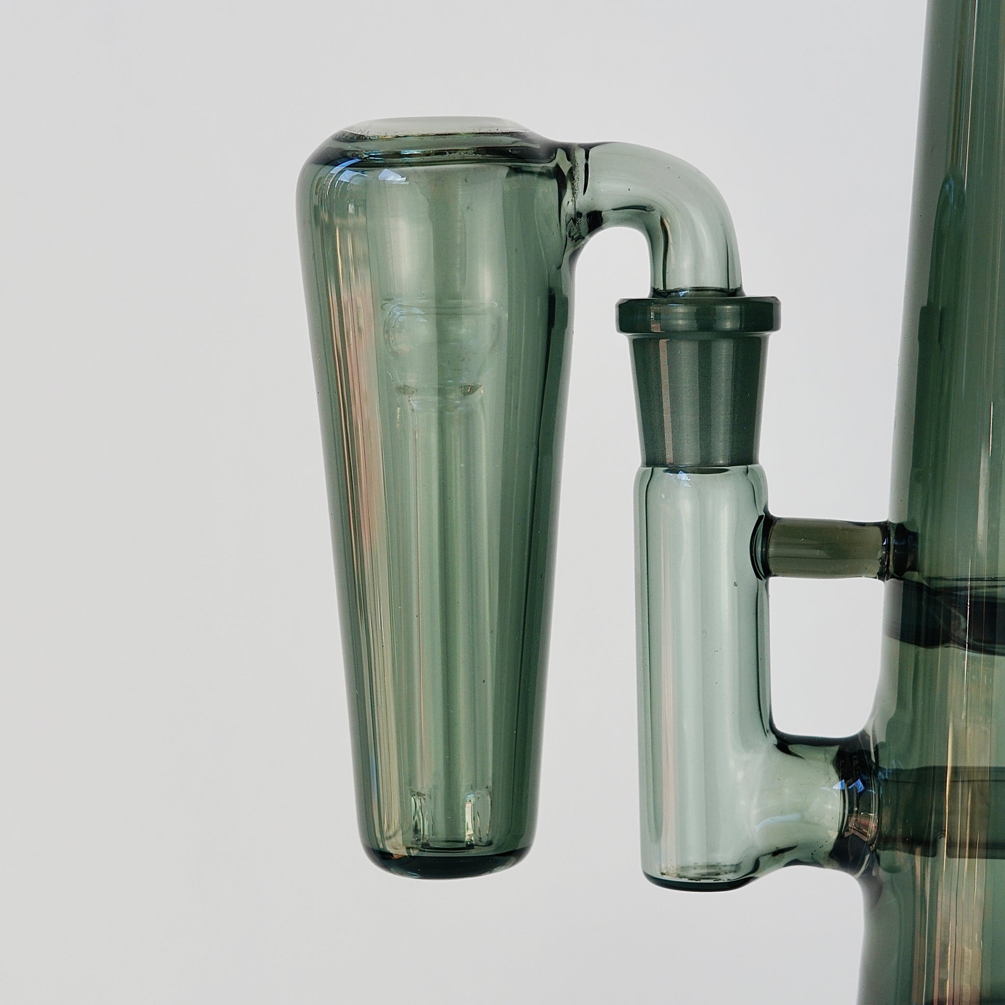 Close up of conical grey glass ash catcher, fit on a 90 degree joint bong