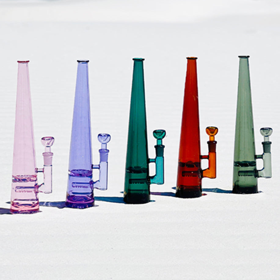 Five Mimi bongs lined up. From left to right: pink, purple, teal, amber, smoke grey