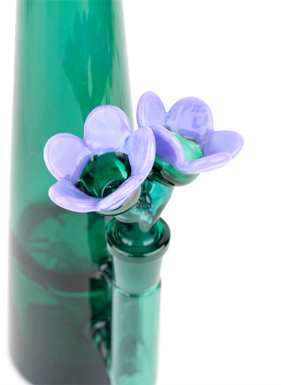 Bowl piece in bong. It's a double bowl piece with flower shaped bowls. The stem of the flower is transparent teal and the petals are opaque purple.