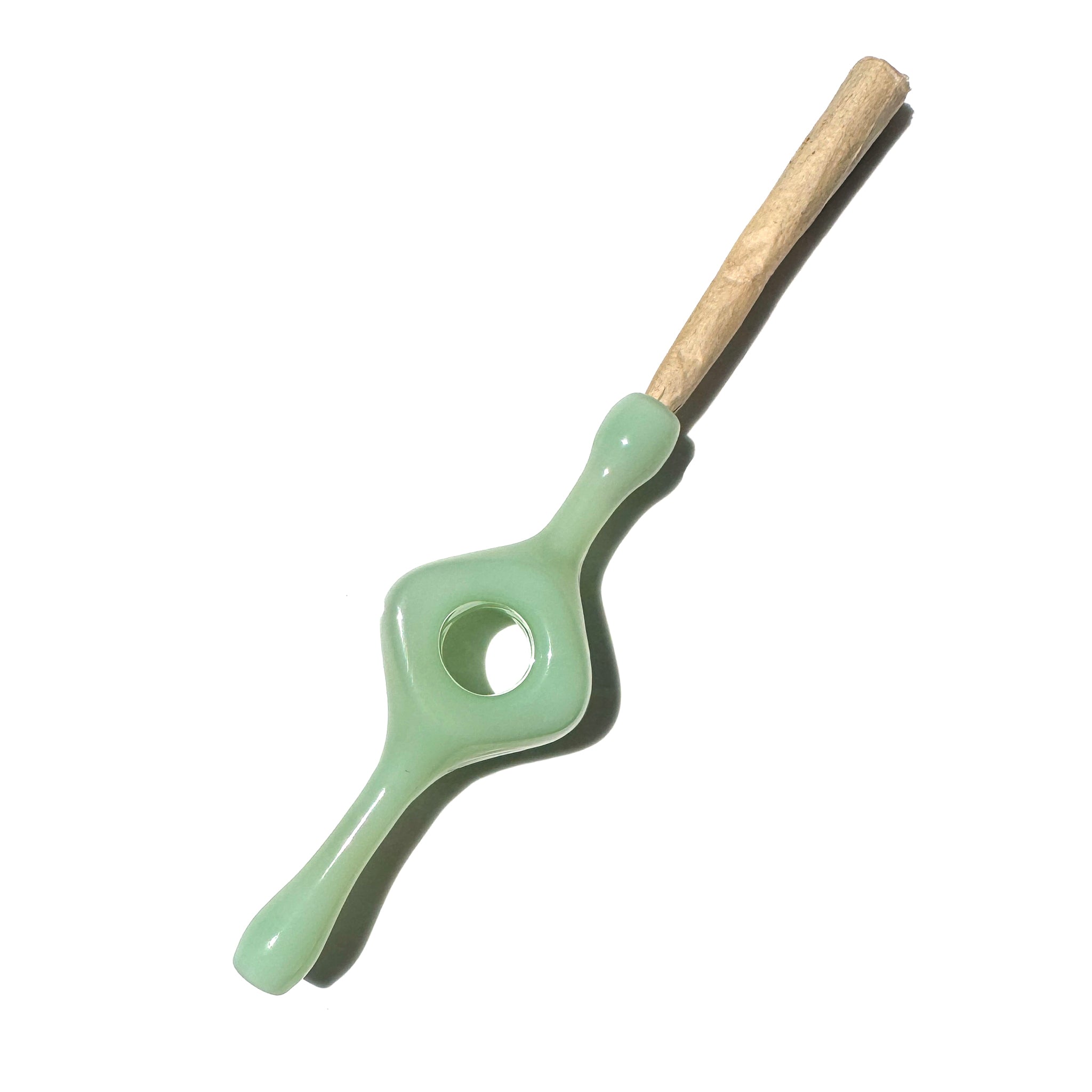 An opaque glass joint holder with a hole in the middle designed for better grip and a smoother smoke. 