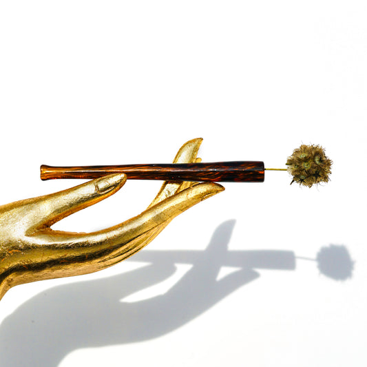 Gold prop hand holding glass tortoise shell joint holder