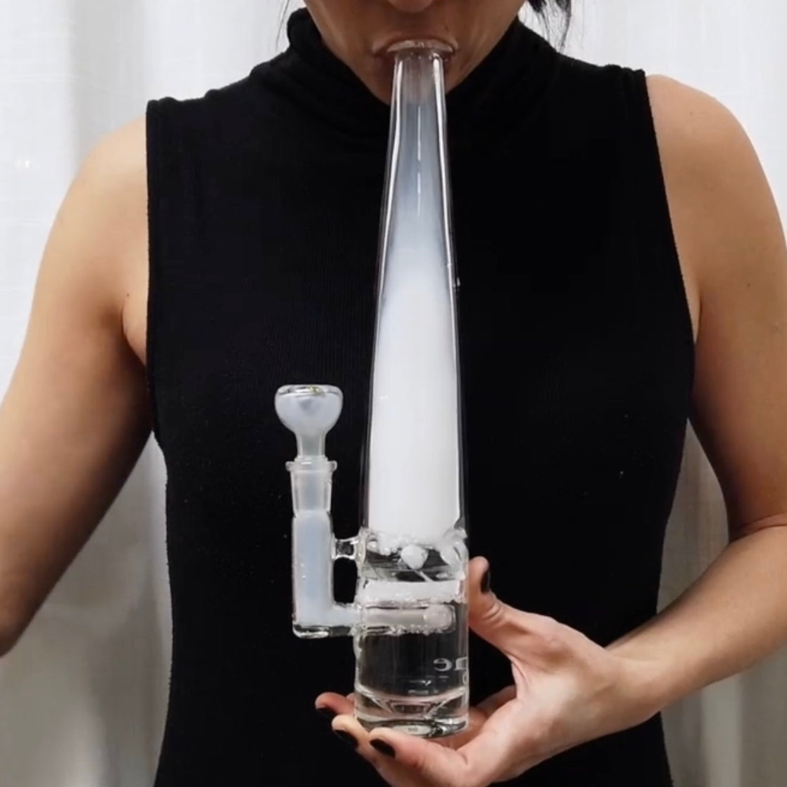 Woman smoking from Mimi bong, smoke fills clear bong 