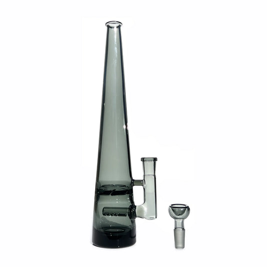 12 inch tall monochromatic grey glass bong, standing tall with joint to right, bowl piece on the surface next to the base